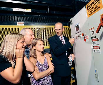 Gov. John Baldacci presses a button to start the machinery.