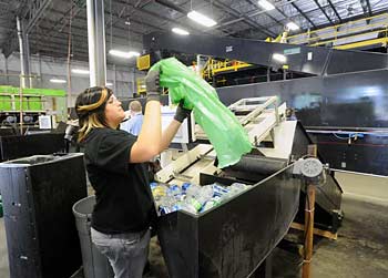 Jade Wildes dumps a bag of returnables into the sorter.